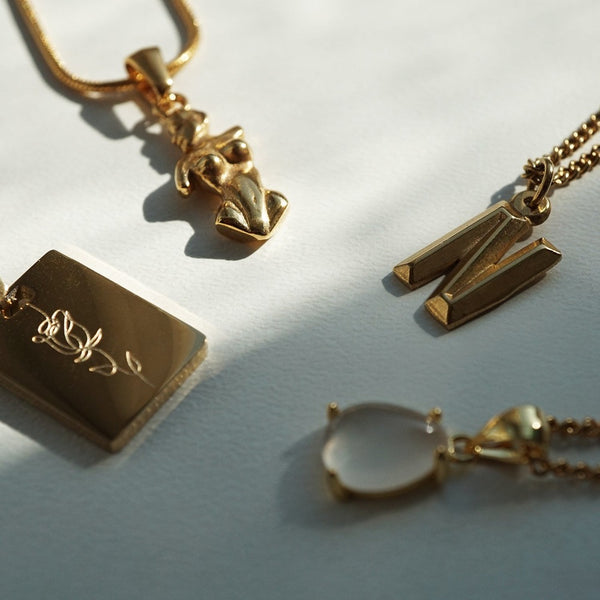 NIKITA custom initial pendant necklace with a unique, personalised letter design. A water-resistant 18k gold plated pendant and adjustable chain made with a hypoallergenic stainless steel base. Christmas everyday jewellery gift for her.