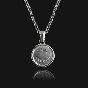 NIKITA 'I am Enough' engraved pendant necklace with a unique wax stamp inspired design. A water-resistant pendant and adjustable chain made with a hypoallergenic stainless steel base. Christmas everyday jewellery gift for her.