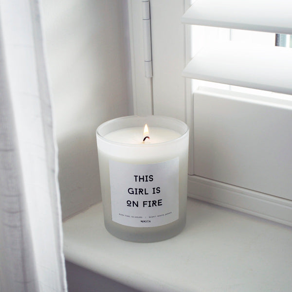 NIKITA Empowering white frosted glass candle, labelled 'Ignite your inner power'. Featuring a white jasmine scent. Christmas or birthday home decor gift for her.
