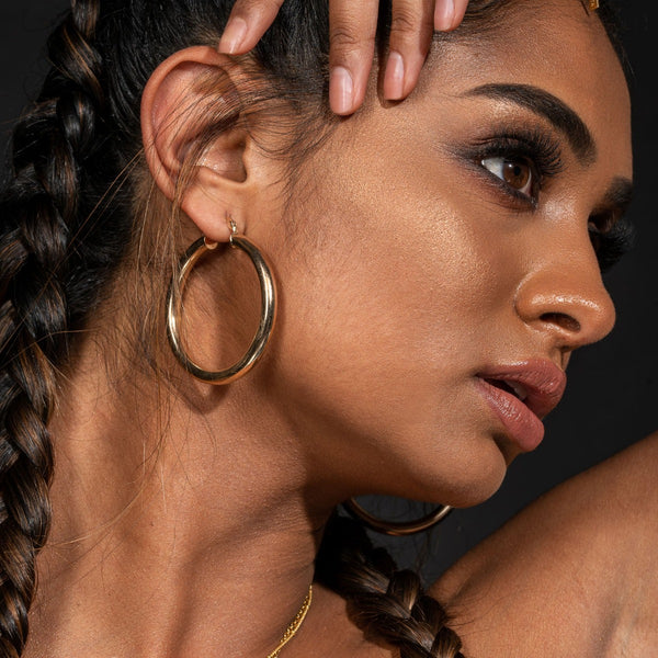 NIKITA Lexi large thick hoop statement earrings with an 18k gold plated finish. Hoops for women made with a quality water-resistant, hypoallergenic stainless steel base. Christmas everyday jewellery gift for her.
